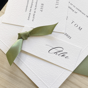 Name card with sage green ribbon tied onto it