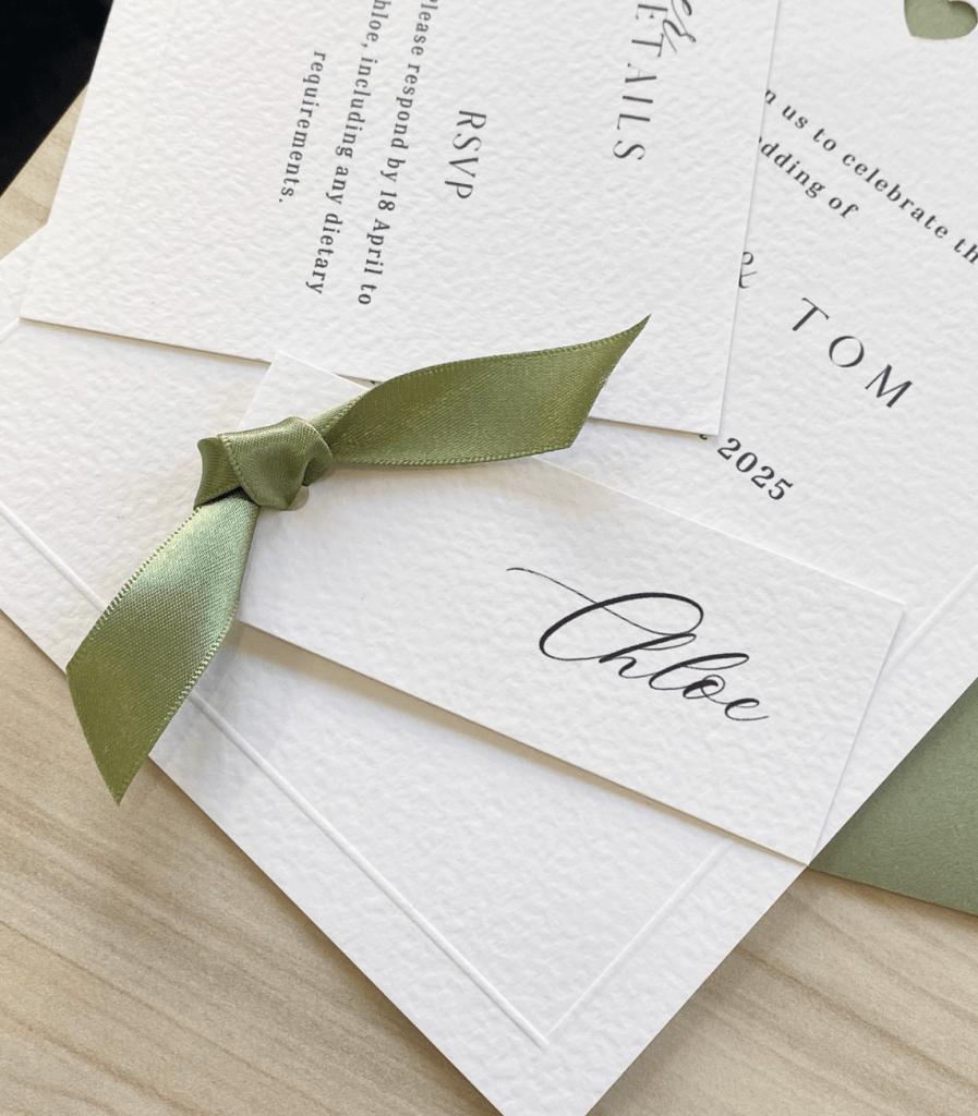 Name card with sage green ribbon tied onto it